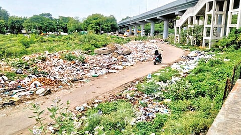 Garbage piling up on both sides of the road connecting Pallavaram Railway Station with GST Road