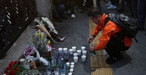 A man pays tribute near the scene of the stampede during Halloween festivities