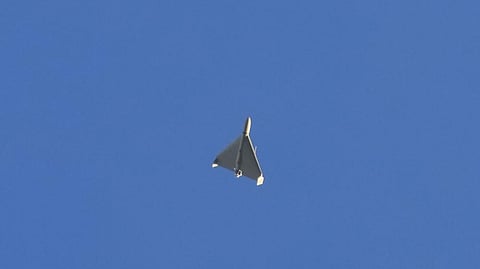 A drone is seen in the sky seconds before it fired