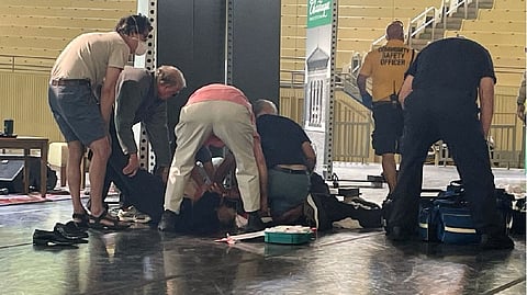 Salman Rushdie is tended to after he was attacked during a lecture on Aug. 12, 2022.