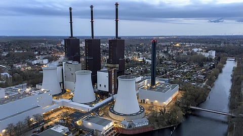 Steam leaves a cooling tower of the Lichterfelde gas-fired power plant