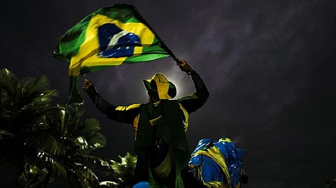 A supporter of Brazil's President Jair Bolsonaro reacts while gathering with fellow supporters outside Bolsonaro's home