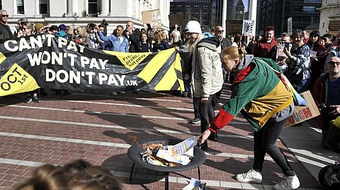 Protesters burn symbolic energy bills outside the ICC in Birmingham prior to the Conservative Party conference at the ICC, Birmingham.