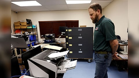 Will Stewart, voting operations manager with the Leon County Supervisor of Elections office, runs tests on a ballot scanner ahead of the midterm elections