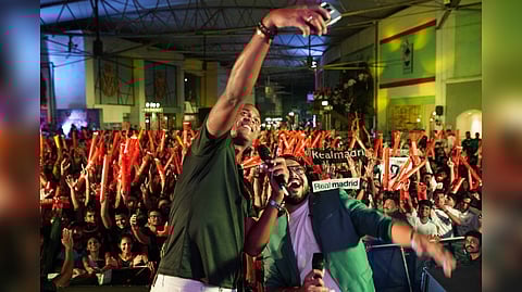 La Liga Ambassador to India Patrick Kluivert (left) takes a picture with a fan during the screening of El Clasico in Mumbai.