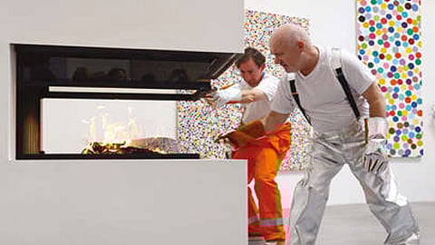 The Turner prize winner and assistants used tongs to deposit individual pieces stacked in piles into fireplaces in the gallery