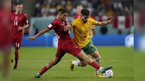 Australia's Mathew Leckie, right, challenges for the ball with Denmark's Alexander Bah during the World Cup group D soccer match between Australia and Denmark, at the Al Janoub Stadium in Al Wakrah, Qatar.