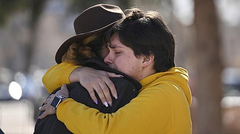 Leia-jhene Seals, left, hugs Carter Rodriguez outside All Souls Unitarian Church before a vigil for the victims of an overnight fatal shooting at Club Q, an LGBTQ nightclub, Sunday, Nov. 20, 2022, in Colorado Springs, Colo.