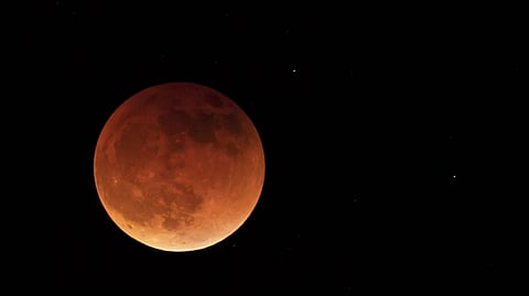 The moon is shown during a full lunar eclipse, Sunday, May 15, 2022, near Moscow, Idaho, with the reddish color caused by it passing into the shadow of the Earth.