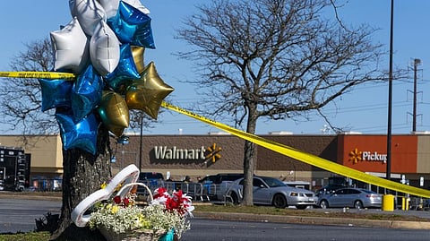 Flowers and balloons have been placed near the scene of a mass shooting at a Walmart.
