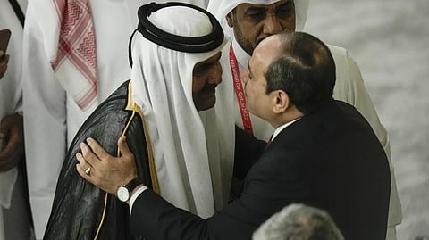 Former Emir of Qatar Sheikh Hamad bin Khalifa Al Thani, centre left, and Egyptian President Abdel Fattah el-Sisi, right, greet each other before the start of the World Cup, group A soccer match between Qatar and Ecuador at the Al Bayt Stadium in Al Khor, Qatar.