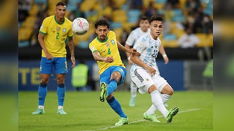 Brazil's Marquinhos in action with Argentina's Lautaro Martinez