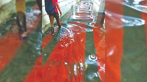 A commuter wades through a flooded subway on Friday