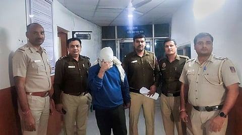 Police personnel along with accused Aftab Ameen Poonawala pose for the media, at Mehrauli Police Station, in New Delhi.