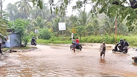 The flooded Punganpalayam Road giving tough time to vehicle users after overnight rain in Coimbatore on Wednesday