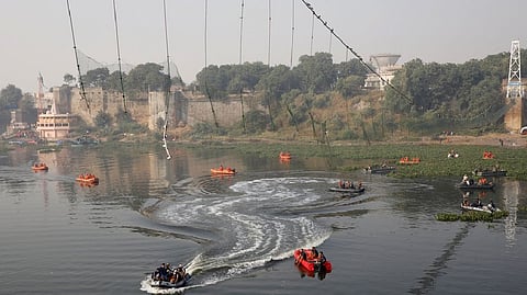 Rescuers conduct search operation after a suspension bridge collapsed on Sunday, in Morbi town in the western state of Gujarat