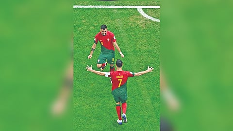 Portugal's Cristiano Ronaldo celebrates his team's first goal with team-mate Bruno Fernandes