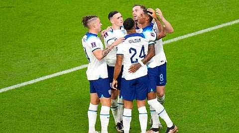 England's Marcus Rashford, right, celebrates with teammates after scoring his side's third goal
