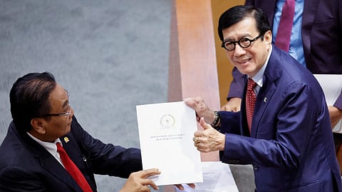 Yasonna Laoly, Indonesian Minister of Law and Human Rights, receives the new criminal code report from Bambang Wuryanto, head of the parliamentary commission overseeing the revision, during a parliamentary plenary meeting in Jakarta, Indonesia.
