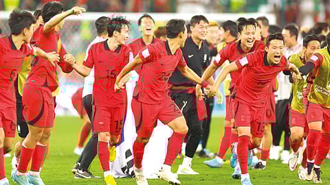 South Korea?s players celebrate after qualifying for knockout stages