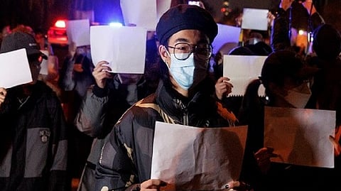 People gather for a vigil Protesters gather for a vigil against 'Zero Covid' policy in Beijing, China.