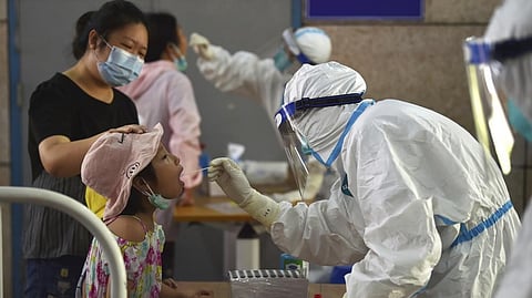 A nurse takes swab samples in the new rounds of Covid-19 testing in Nanjing in eastern China's Jiangsu province.