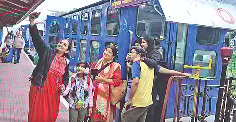 Tourists taking selfies before commencing their journey by the NMR train in The Nilgiris on Monday