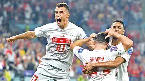 Switzerland?s midfielder Xherdan Shaqiri celebrates with team-mates after scoring a goal against Serbia