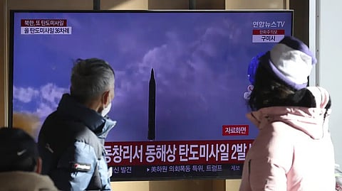 People watch a TV screen showing a news program about North Korea's missile launch with file footage, at the Seoul Railway Station in Seoul, South Korea, Sunday.