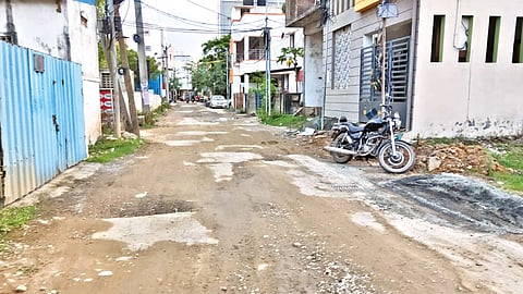 Pothole-ridden road in TVS Nagar, in Korattur North