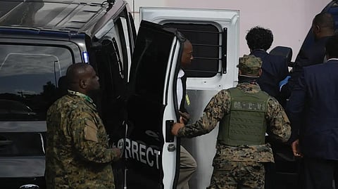 FTX founder Sam Bankman-Fried, top right, is escorted from a corrections van into the Magistrate Court