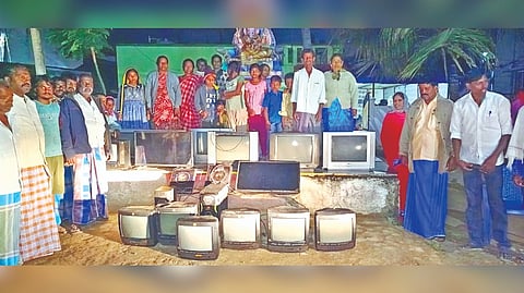 Katterivattam villagers staging protest with damaged TVs late on Friday night in Tirupattur
