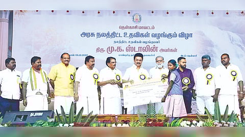 Chief Minister MK Stalin hands over welfare measure to a student at a programme in Tenkasi on Thursday.