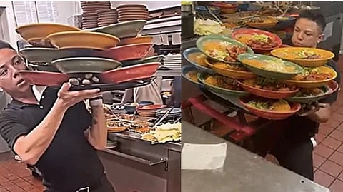 The waiter carrying food on multiple plates