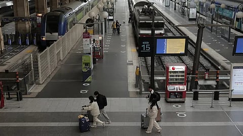 Travelers walk in the deserted Gare du Nord train station