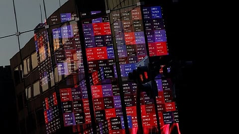 A huge electric stock quotation board is seen inside a building in Tokyo