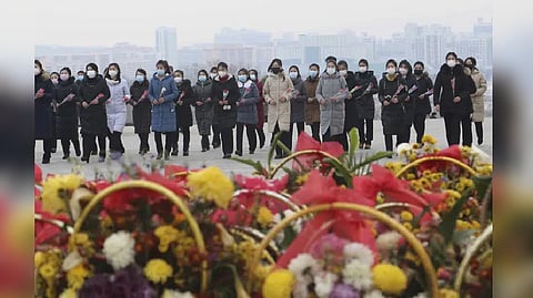 North Koreans paying tributes to the statues of late leaders Kim Sung and Kim Jong