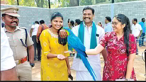 Visitors holding a bird in the newly opened park in old Thanjavur collectorate