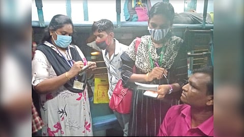 A ticket checking squad booking a violator on a train in Salem division