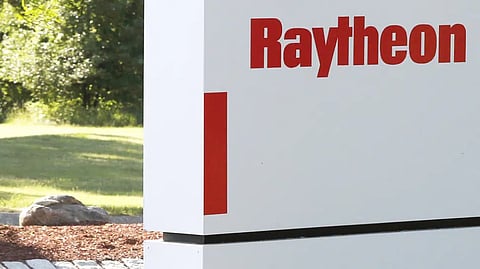 A sign stands at the road leading to the Raytheon facility in Marlborough, Mass.