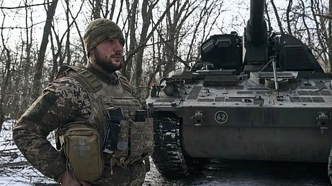 A Ukrainian soldier stands in his position on the frontline close to Bakhmut