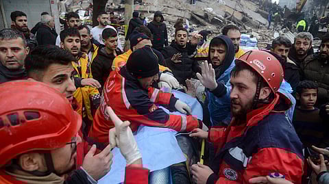 Rescue workers pull out a survivor from the rubble in Diyarbakir, Turkey, on Monday after a 7.8 magnitude earthquake struck the country's southeast.