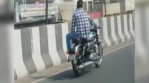 Man performing stunt on a bike in Modarabad.