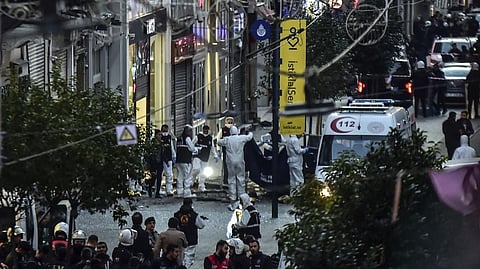 Forensic experts collect a dead body after an explosion on Istanbul's popular pedestrian Istiklal Avenue