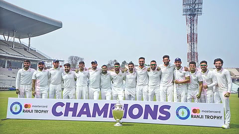 The Saurashtra players pose with the trophy