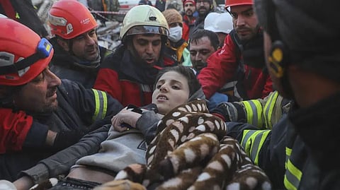 Rescuers carry Muhammed Alkanaas, 12, to an ambulance after they pulled him out five days after the Monday earthquake in Antakya, southern Turkey.