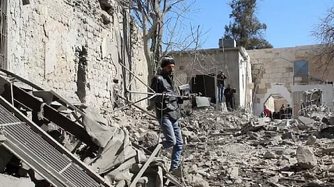 People inspect the damage at the Citadel of Damascus, in the aftermath of what state media said were Israeli air strikes, Syria