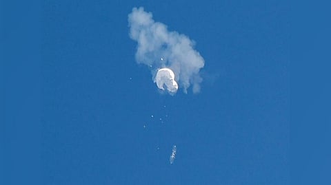 The suspected Chinese spy balloon drifts to the ocean after being shot down off the coast in Surfside Beach