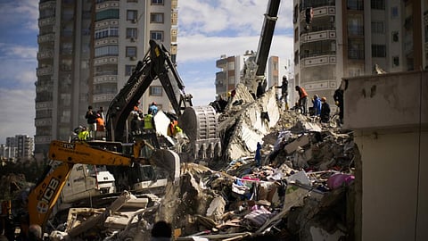 Emergency rescue members search for people in a destroyed building in Adana, Turkey
