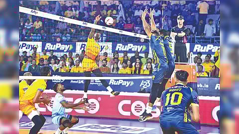 Renato Mendes (airborne in yellow jersey) attempts a spike